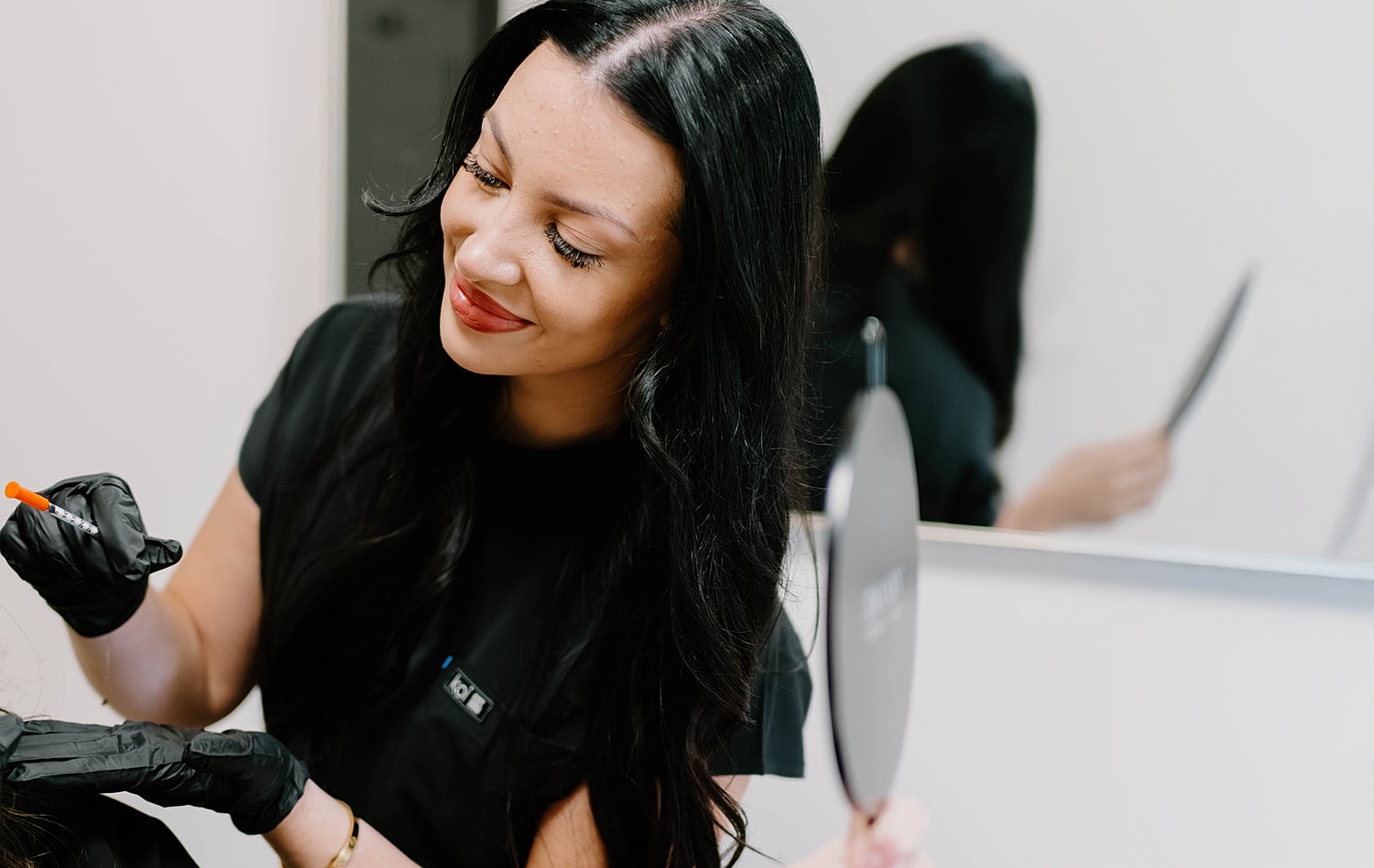 Hair stylist applying treatment in salon setting