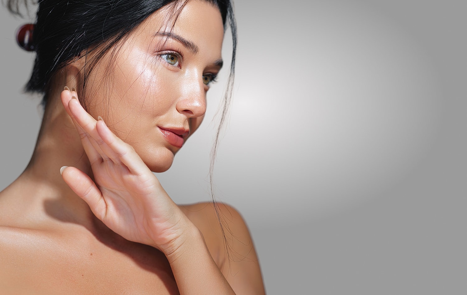 Woman elegantly posing with soft lighting.