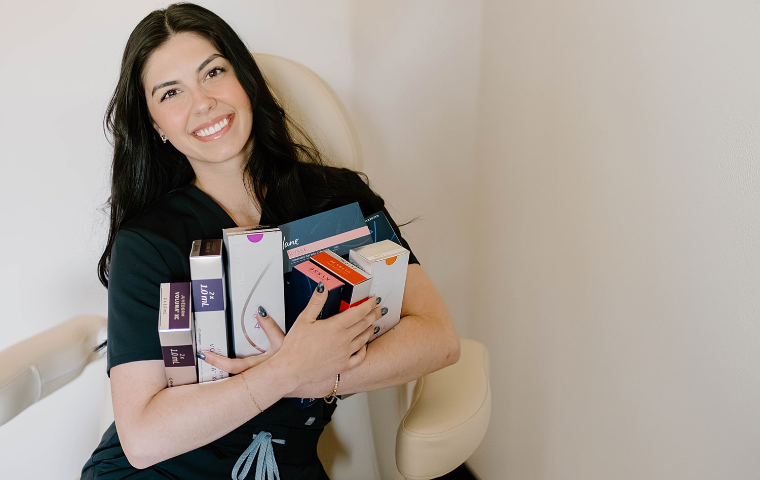 Smiling woman holding skincare product boxes.