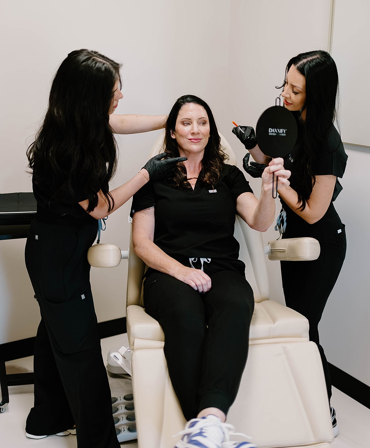 Two professionals assisting a client in treatment.