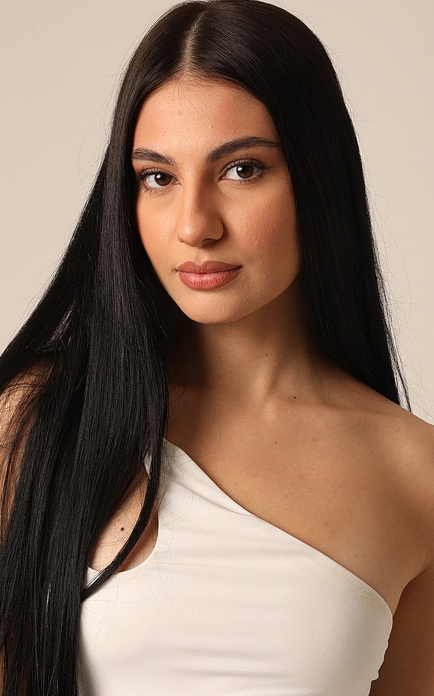 Close-up of a woman with long, black hair.