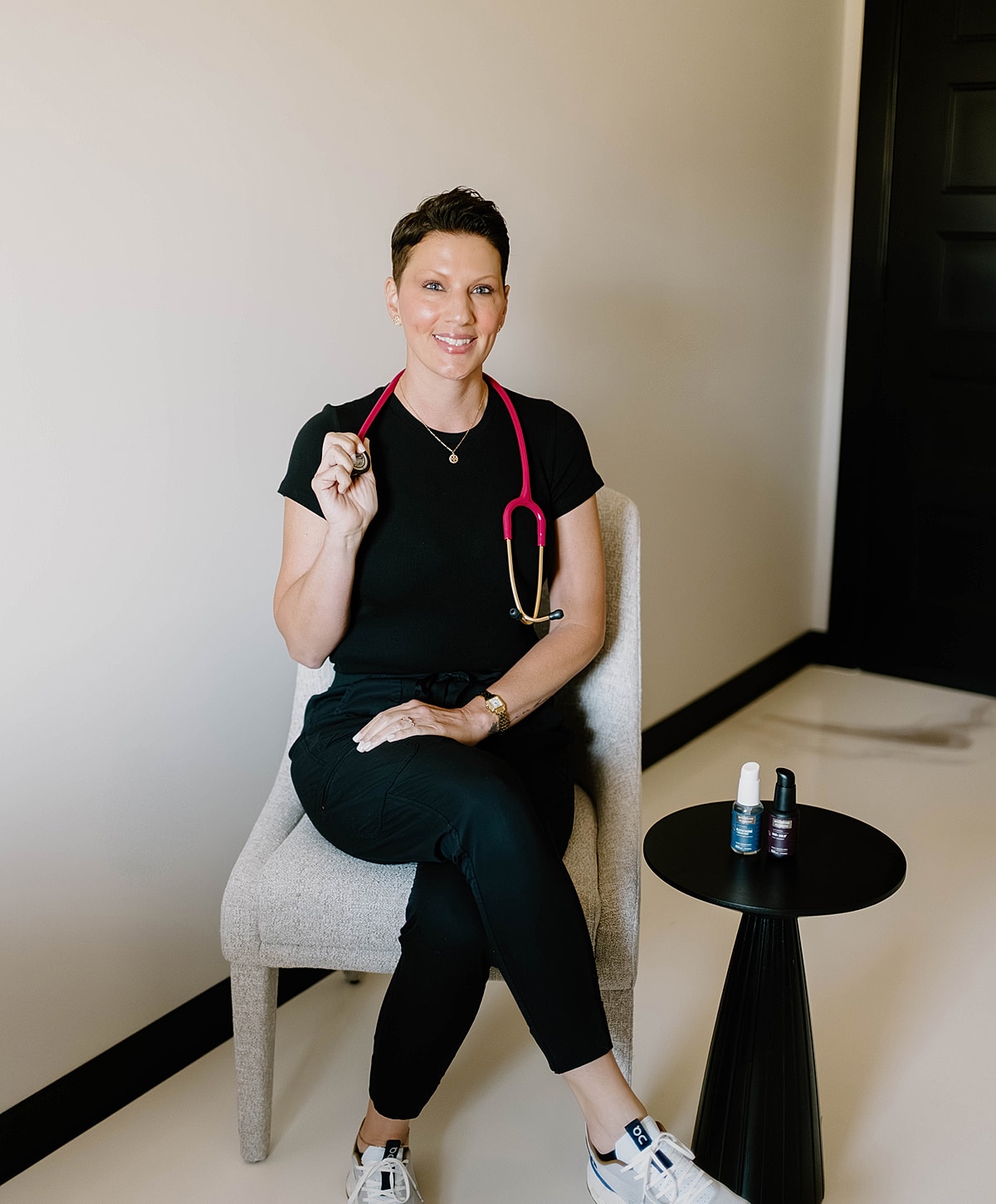 Health professional sitting with stethoscope and products.