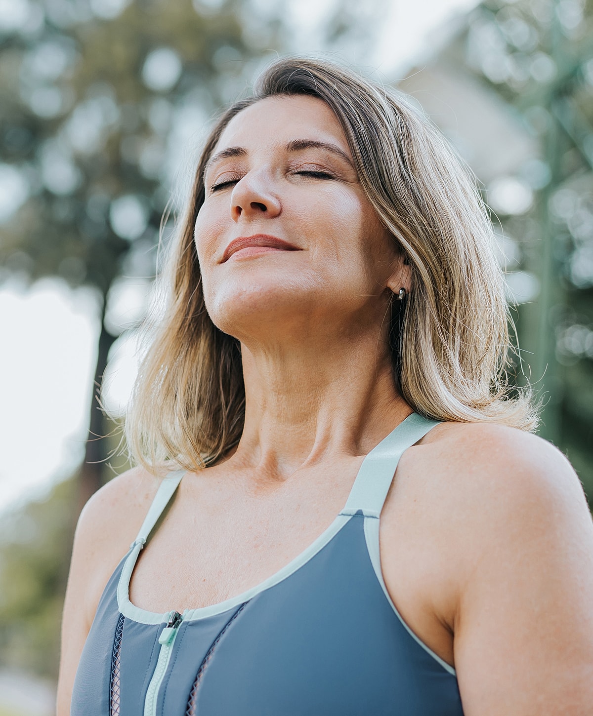 Woman practicing mindfulness outdoors with closed eyes.