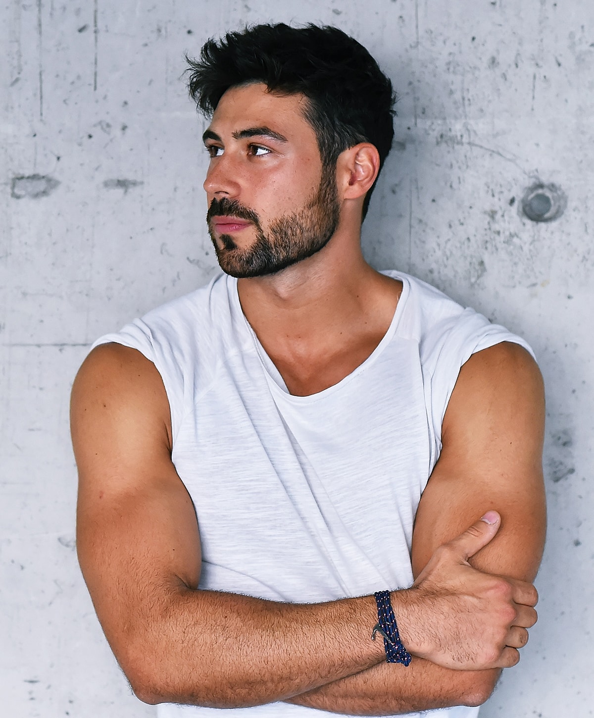 Man in white shirt with crossed arms.