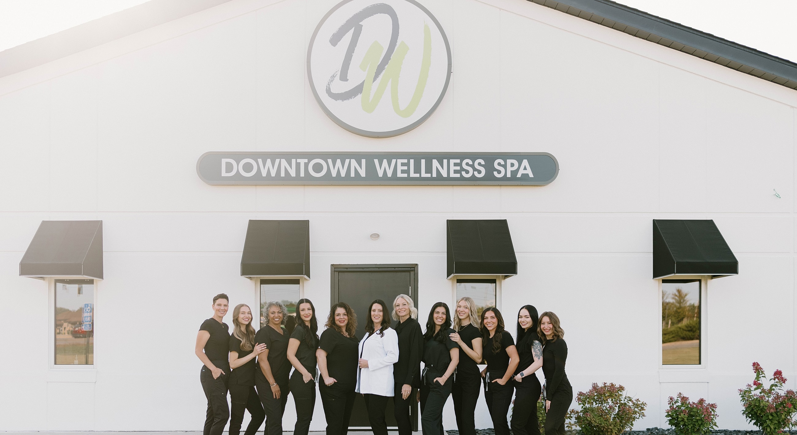 Team outside Downtown Wellness Spa building.