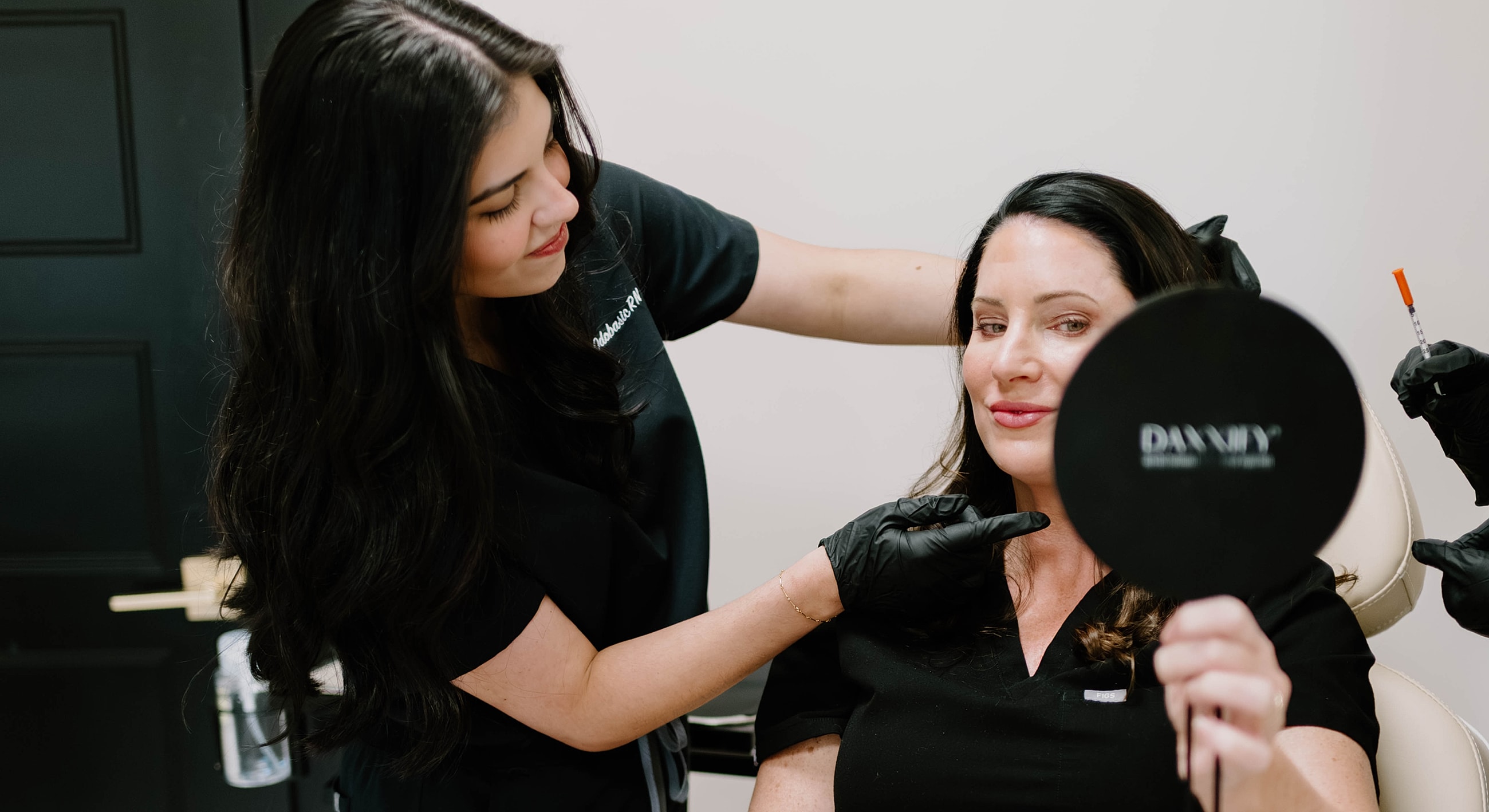 Woman consults with aesthetic professional before treatment.