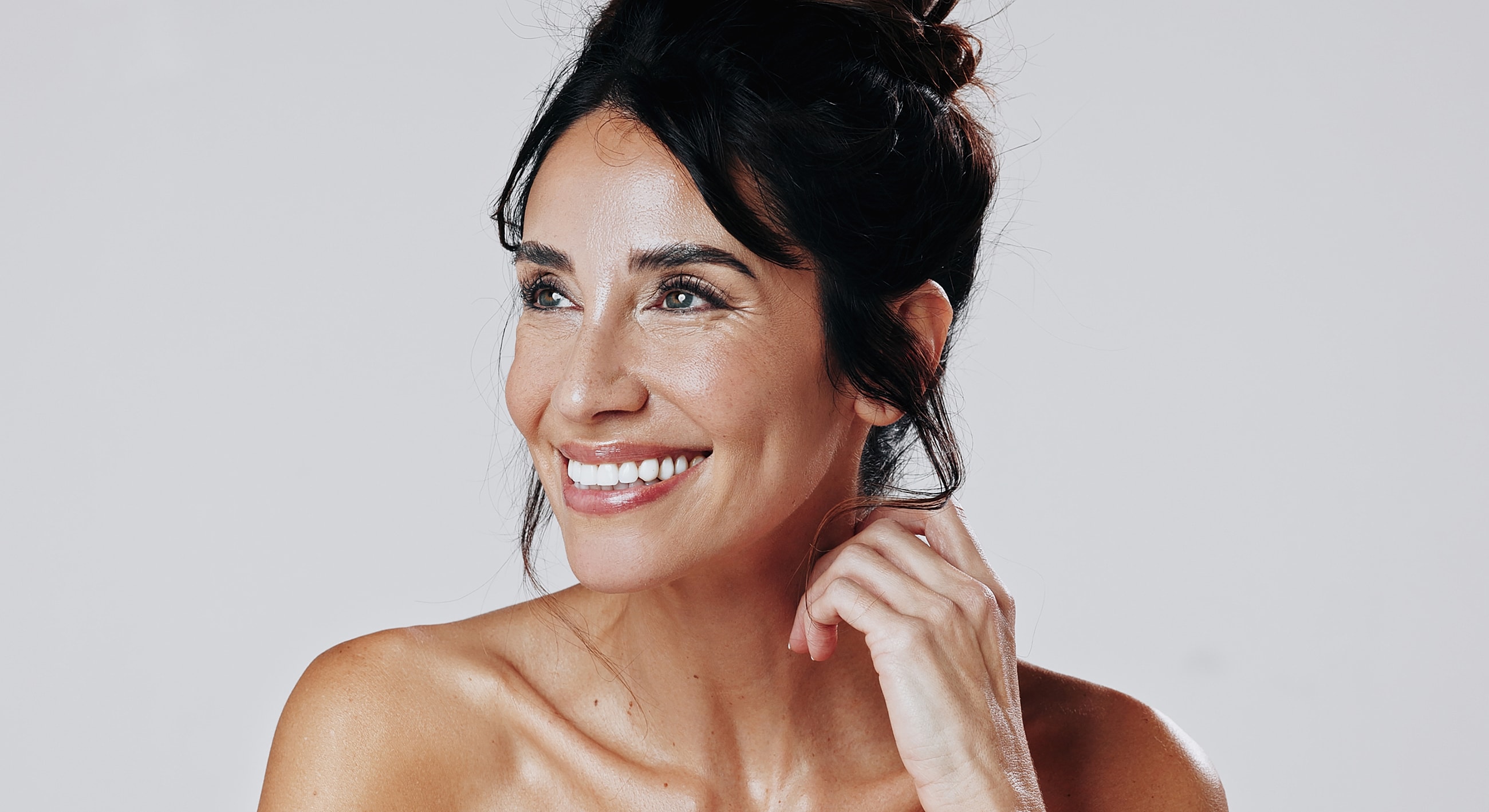 Smiling woman with elegant hairstyle and natural beauty.