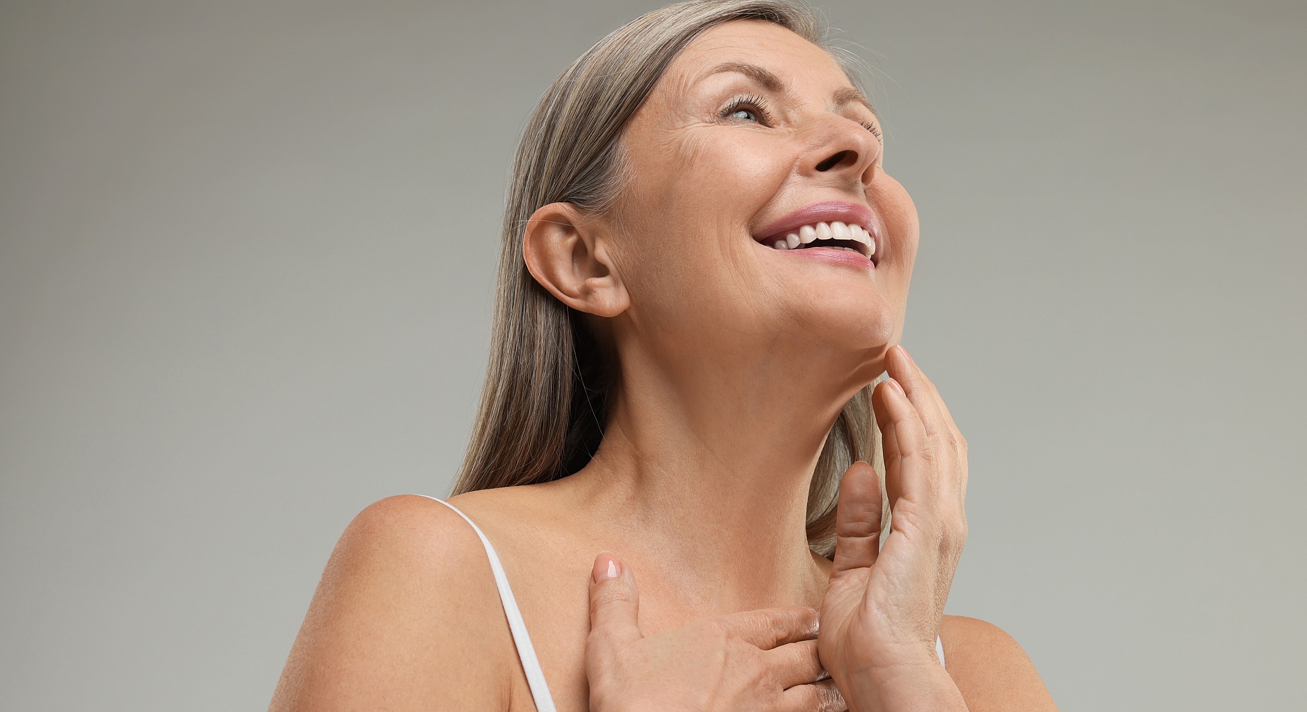 Smiling woman touching her face, natural beauty.
