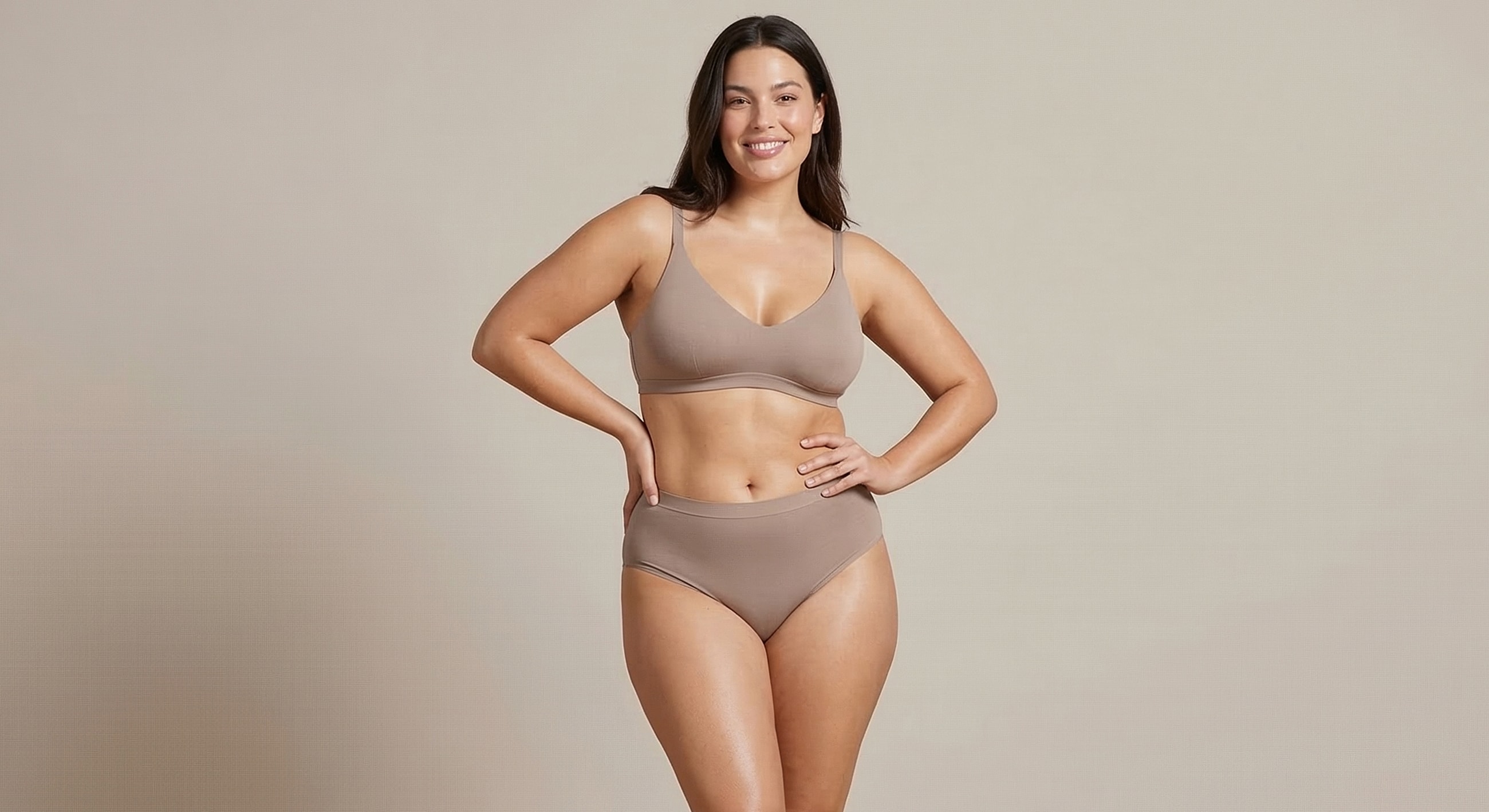 Smiling woman in brown lingerie set.