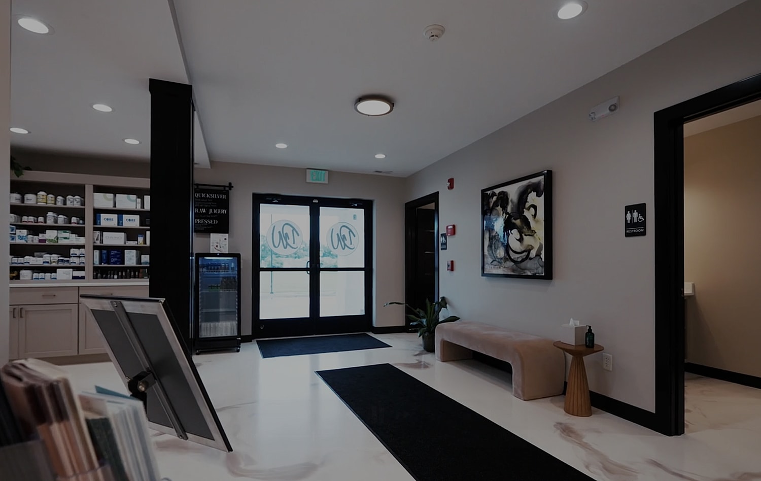 Modern wellness center reception area with products.